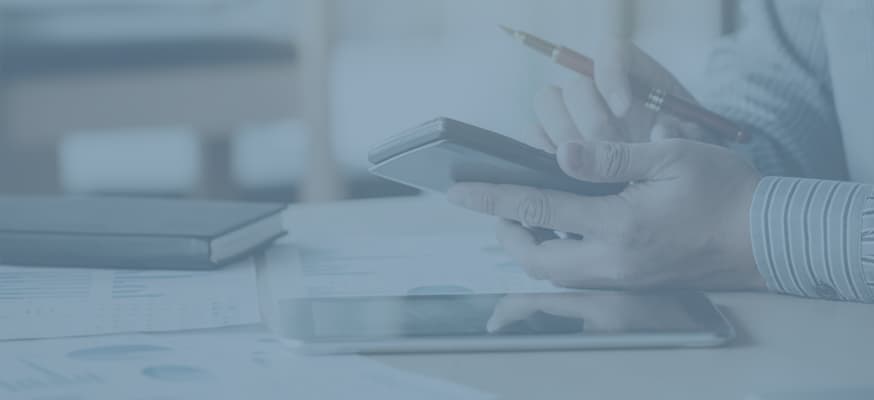 A close-up of someone performing calculations on their mobile devices.