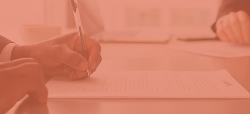 A close-up of a business man filling out a form.