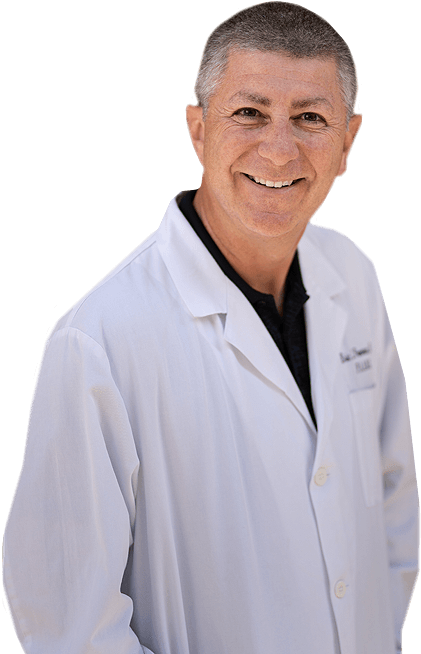 An upper body shot of Dr. Eric Freeman in a white doctor’s coat.