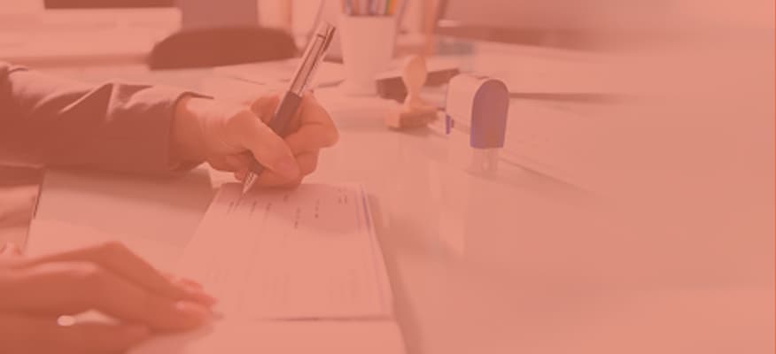 A close-up of someone writing a check.