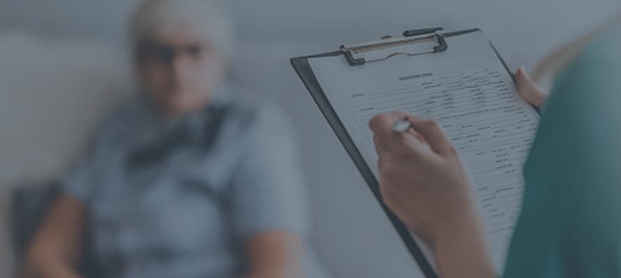 A close-up of someone taking notes on a clipboard.