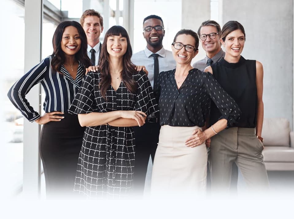 A front-facing group shot of people in an office.